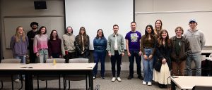 A posed photo of attendees standing with the panelists at the UCo Climate Career Panel.