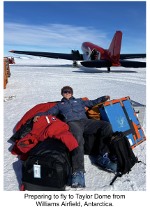 A person laying on top of their cold weather and research gear, getting ready to fly to Antarctica.