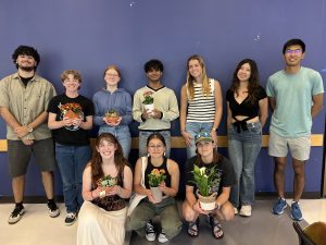 Photo of UCo trivia attendees and their plant prizes