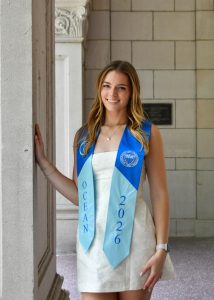 Photo of Elise smiling in her graduation stoll