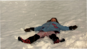 Child making a snow angel