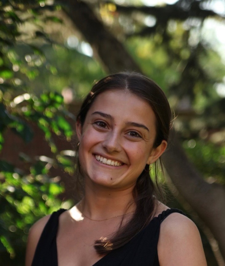 Sophia Ludtke Headshot smiling head tilted outdoors