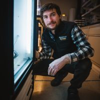 Jacob Chalif profile photo posed squatting in a lab